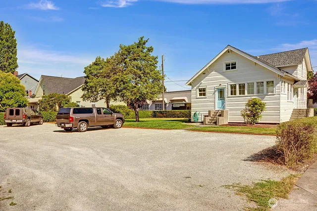 a view of a street with a car parked in front of it