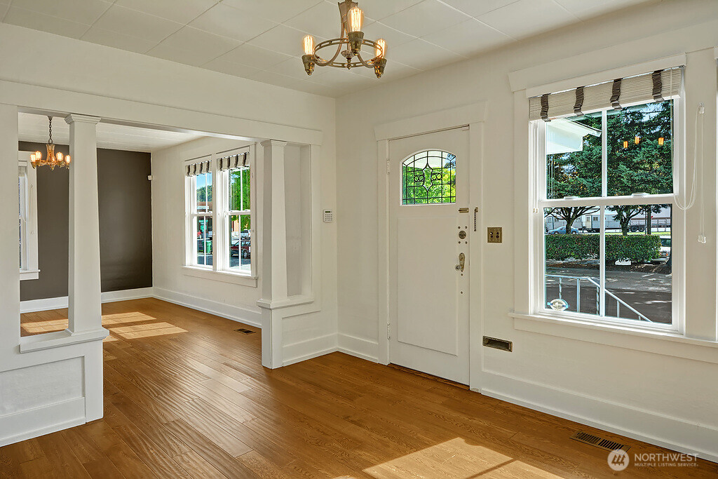 5403 Maynard Avenue South Seattle, WA 98108 - Photo 5 of 26 wooden floor in an empty room with a window