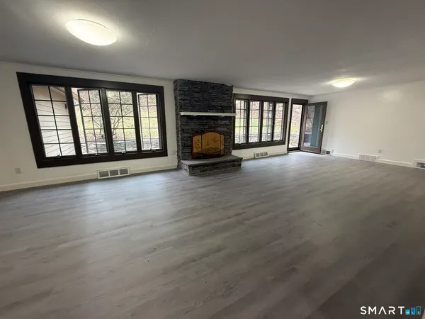 a spacious bathroom with a double vanity sink a bathtub and a window