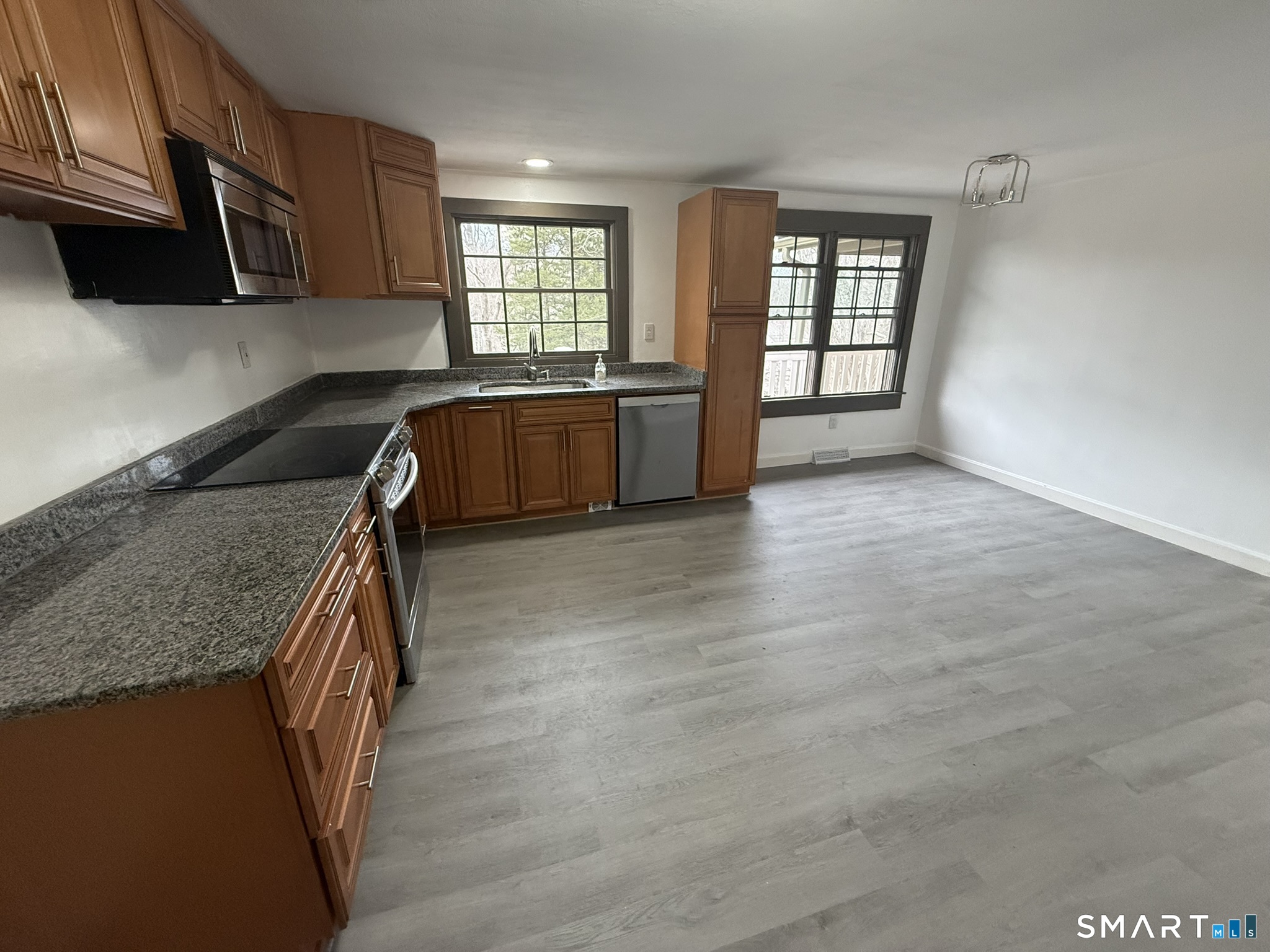 110 Town Woods Road Lyme, CT 06371 - Photo 14 of 37 a kitchen with granite countertop a stove a sink and a microwave