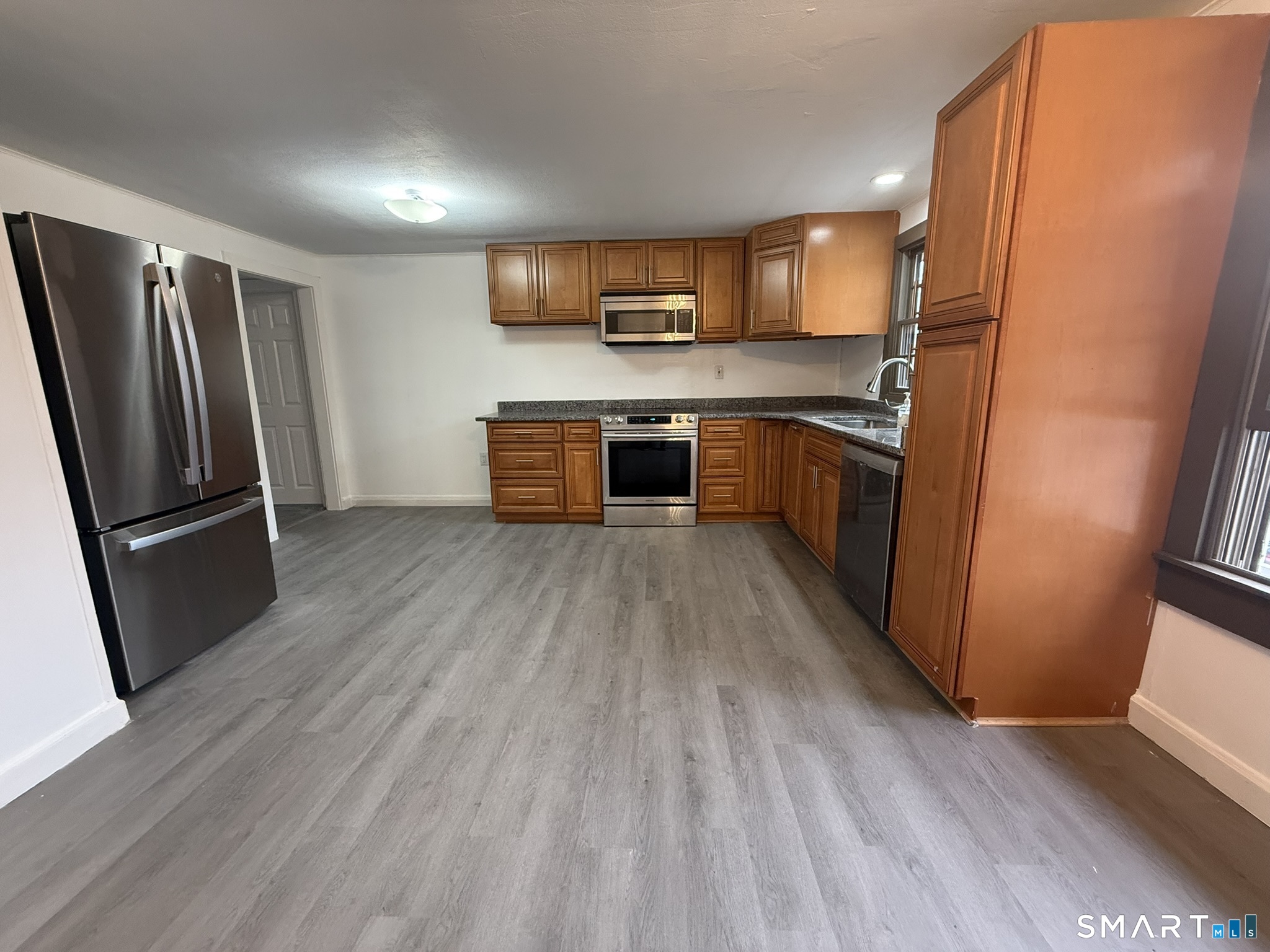 110 Town Woods Road Lyme, CT 06371 - Photo 15 of 37 a kitchen with stainless steel appliances a refrigerator counter space and wooden floor