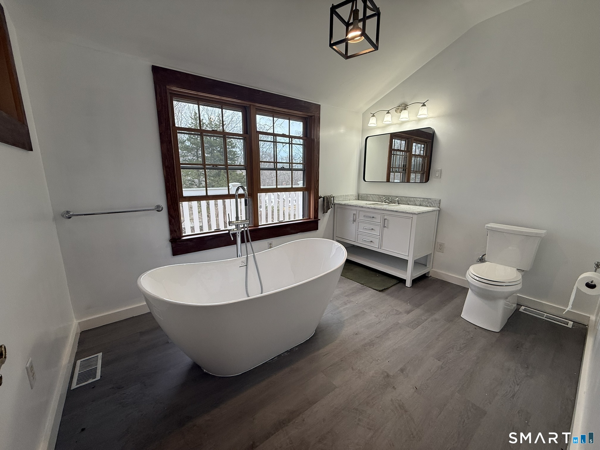110 Town Woods Road Lyme, CT 06371 - Photo 17 of 37 a spacious bathroom with a double vanity sink a bathtub and a window
