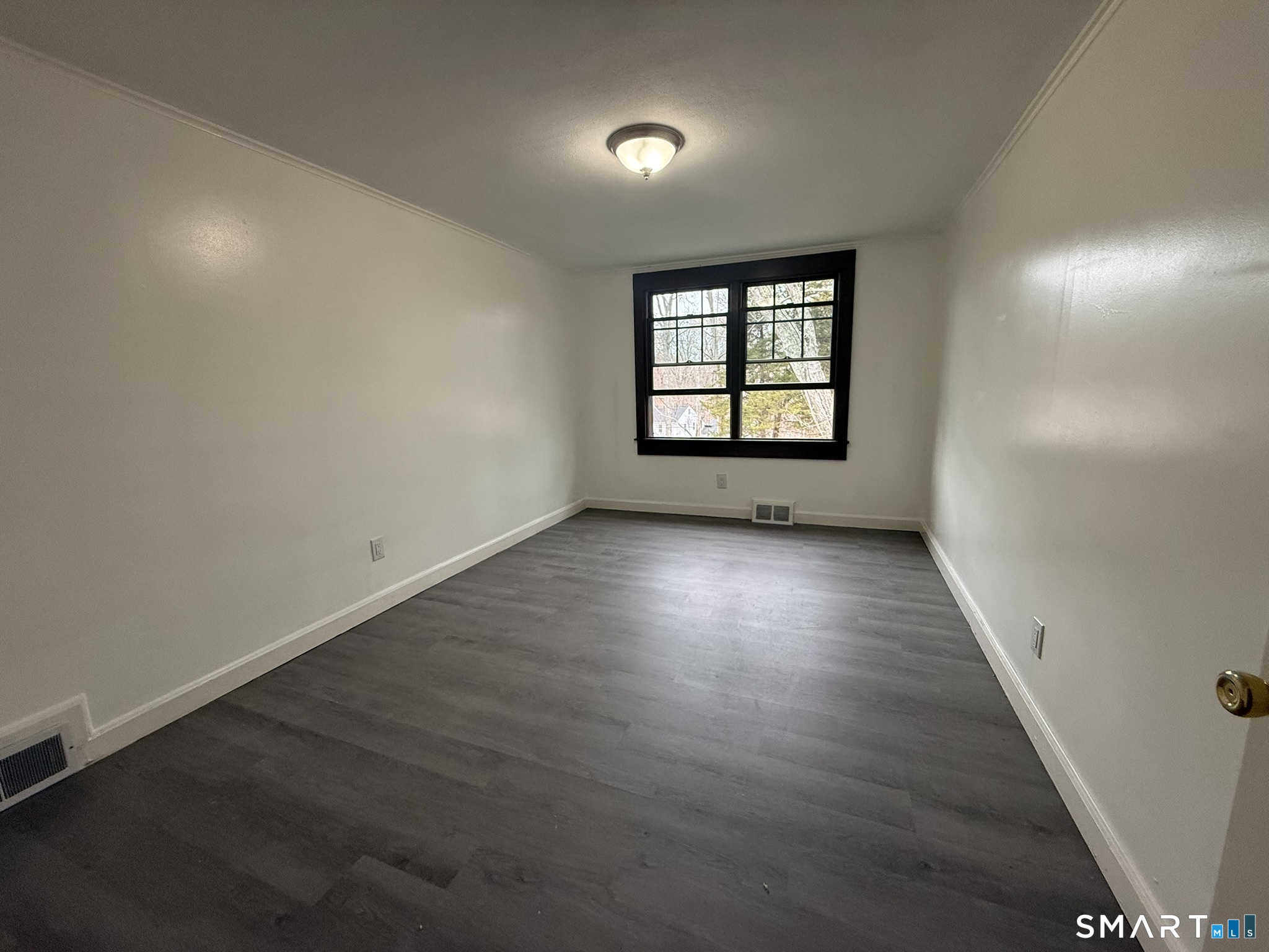 110 Town Woods Road Lyme, CT 06371 - Photo 19 of 37 an empty room with wooden floor and windows