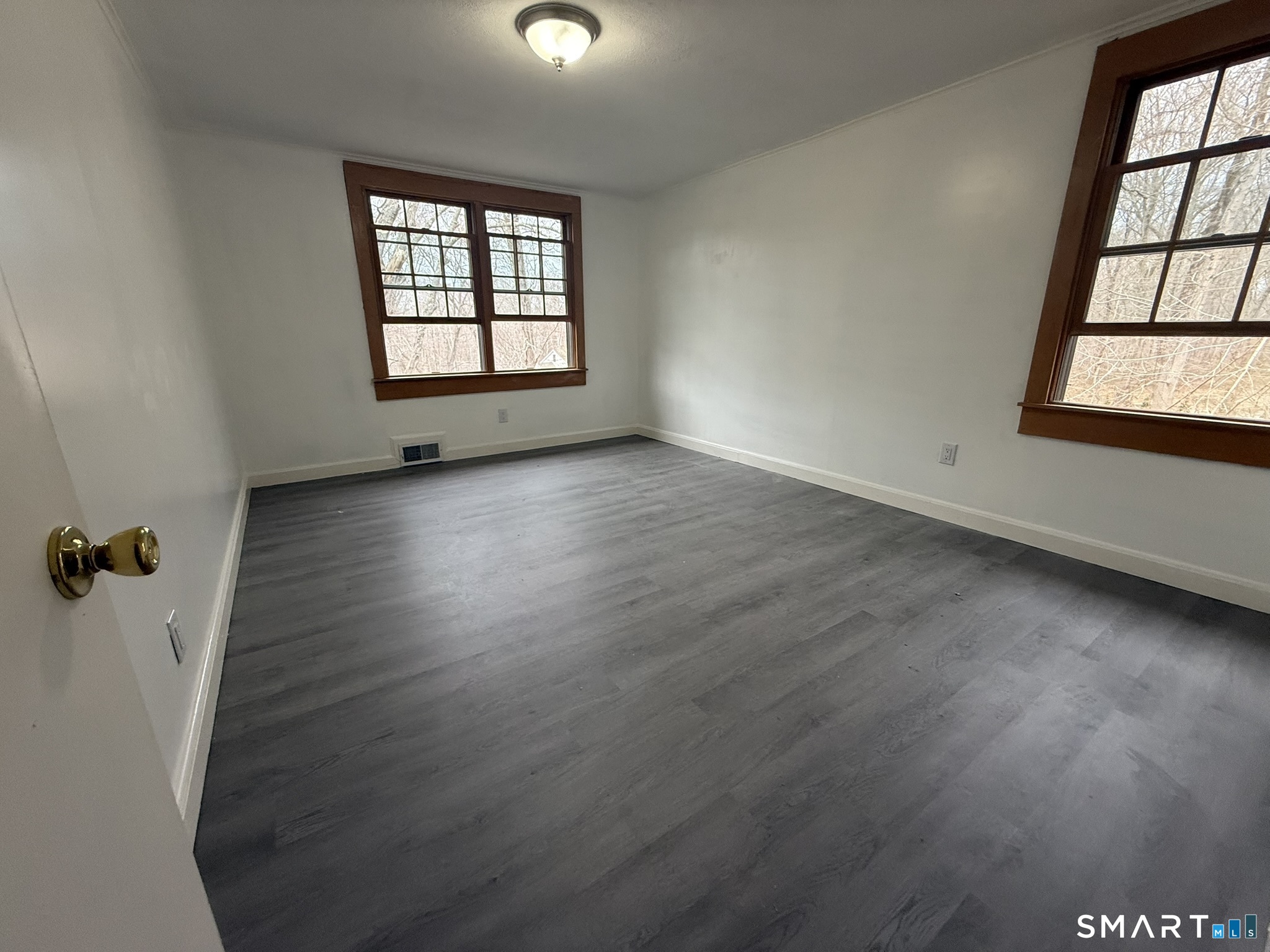 110 Town Woods Road Lyme, CT 06371 - Photo 20 of 37 an empty room with wooden floor and windows