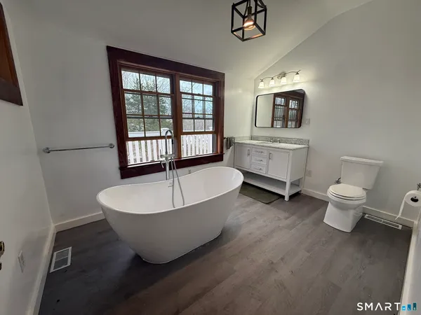 a bathroom with a toilet sink and shower