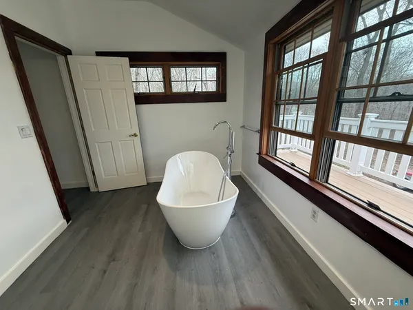 a bathroom with a granite countertop toilet a sink and a mirror