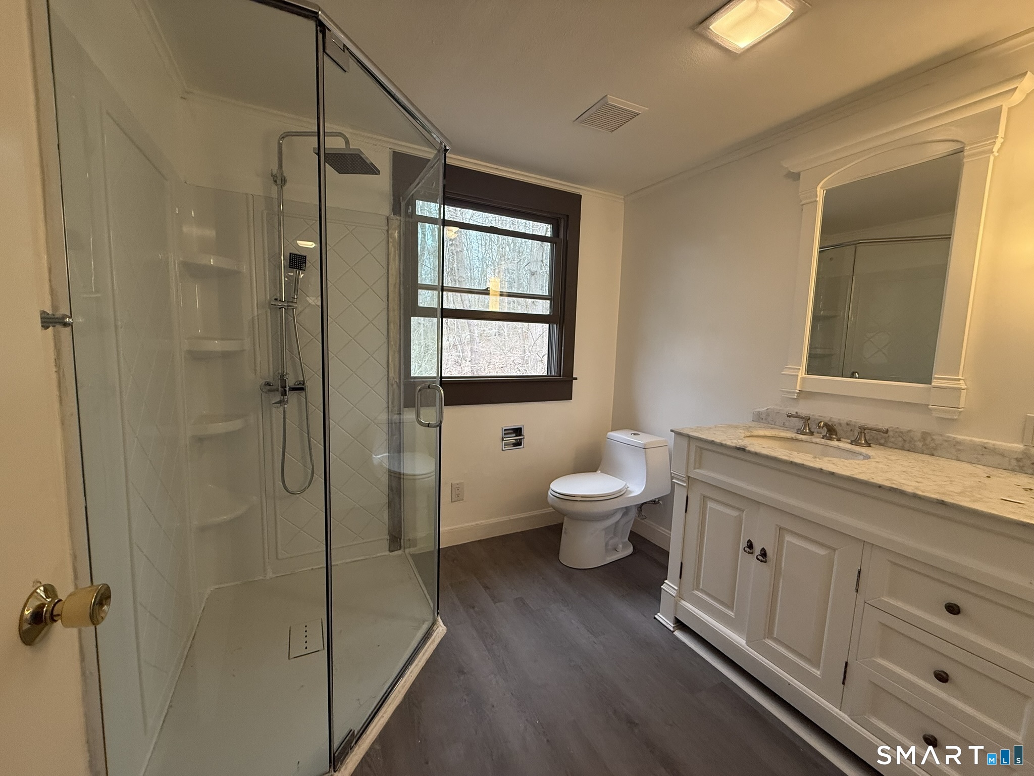 110 Town Woods Road Lyme, CT 06371 - Photo 26 of 37 a bathroom with a granite countertop toilet a sink and a mirror
