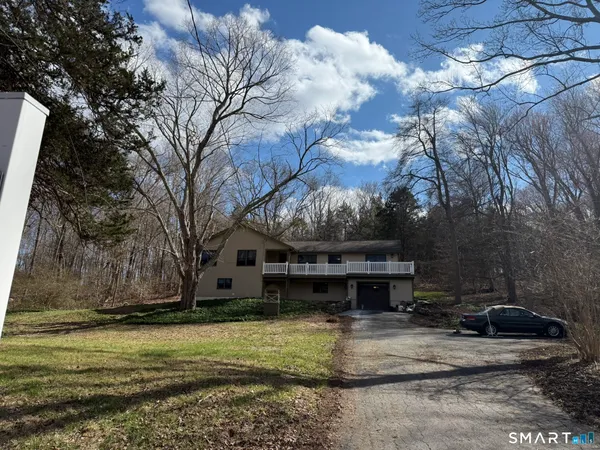 a view of a house with a wooden fence