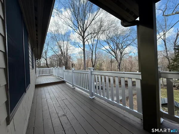 a view of hallway with stairs and wooden floor