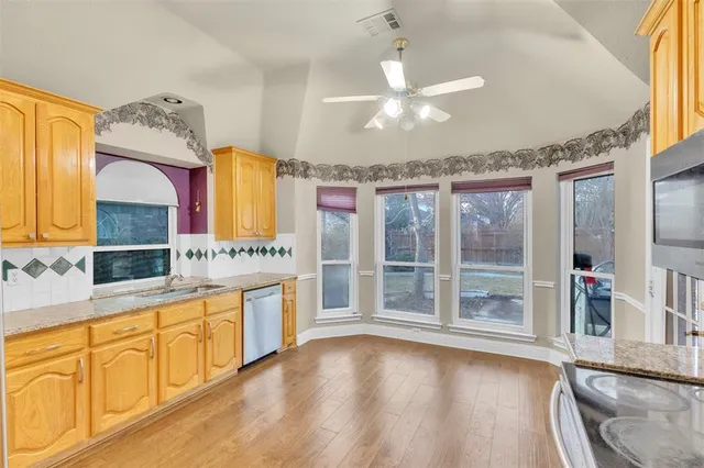 a spacious bathroom with a granite countertop tub sink and mirror