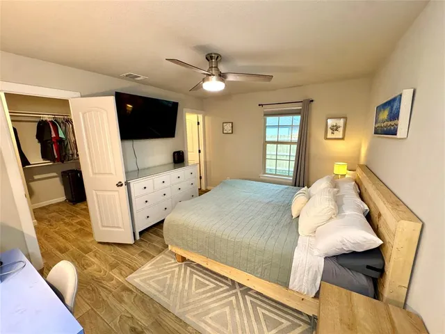 a bedroom with a bed and flat screen tv