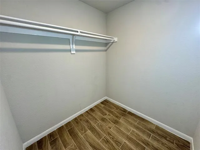 a view of a room with wooden floor