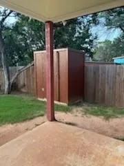a view of a backyard with wooden fence