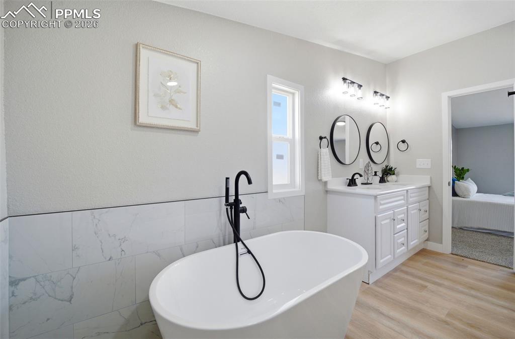 35125 Book Road Yoder, CO 80864 - Photo 16 of 45 a bathroom with a double vanity sink mirror and bathtub