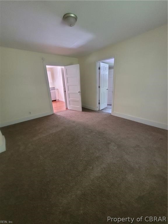 863 Urbanna Road Saluda, VA 23149 - Photo 9 of 24 Unfurnished bedroom featuring dark colored carpet
