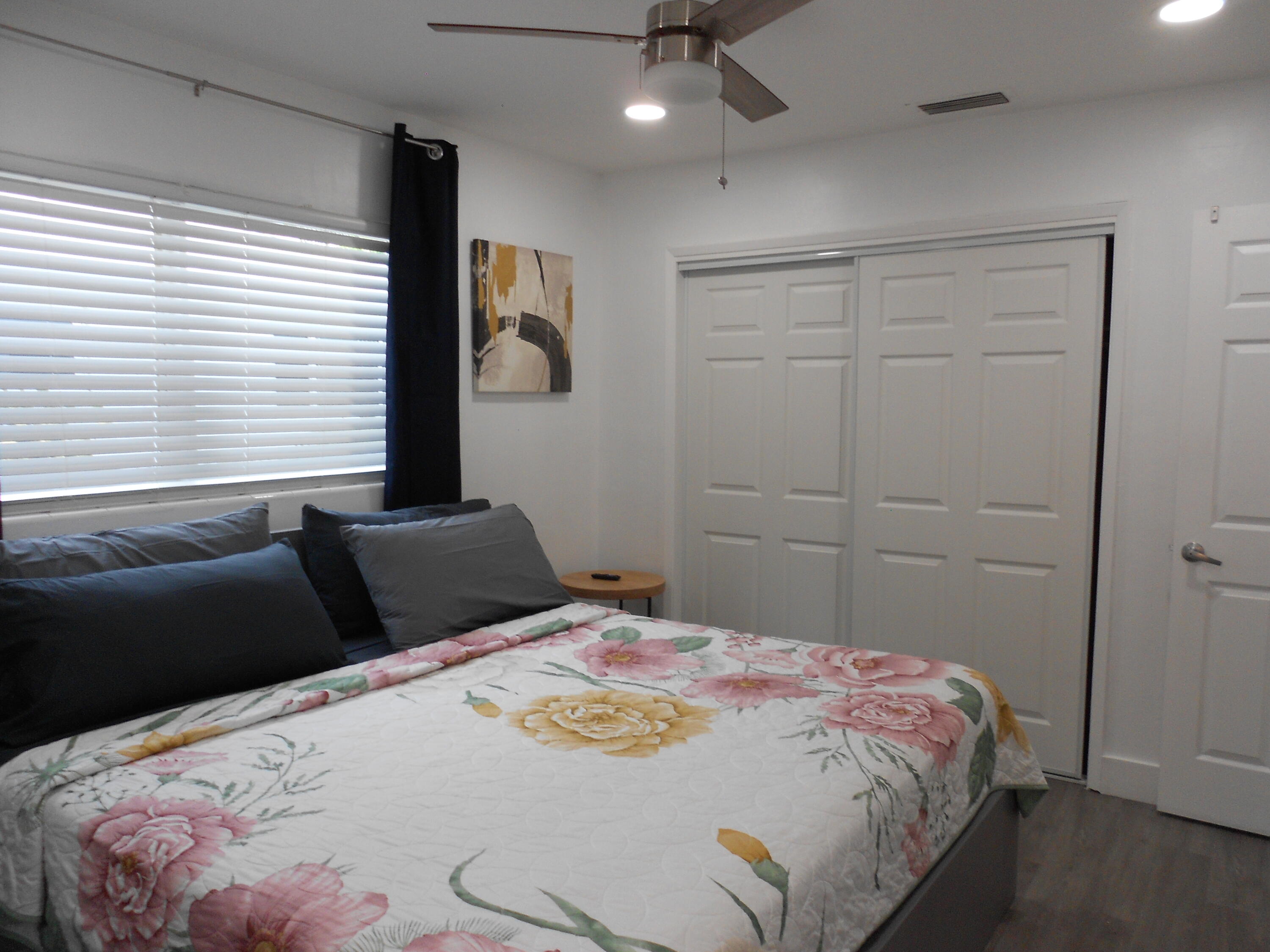 817 Northwest 30th Court Wilton Manors, FL 33311 - Photo 11 of 17 a bedroom with a bed and a chandelier