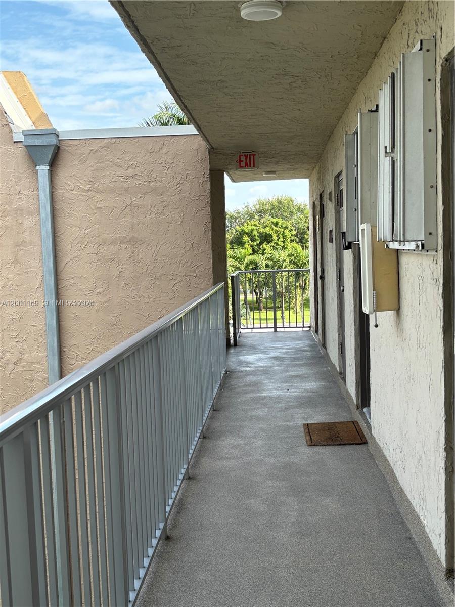 10900 Southwest 104th Street, Unit 303 Miami, FL 33176 - Photo 11 of 40 a view of a pathway of a house with wooden floor