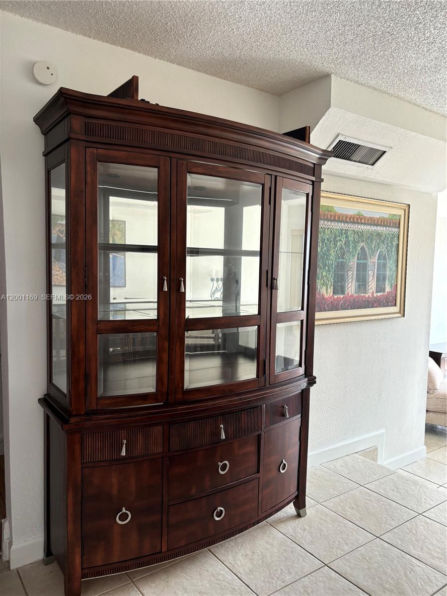10900 Southwest 104th Street, Unit 303 Miami, FL 33176 - Photo 12 of 40 a living room with a large window and cabinets