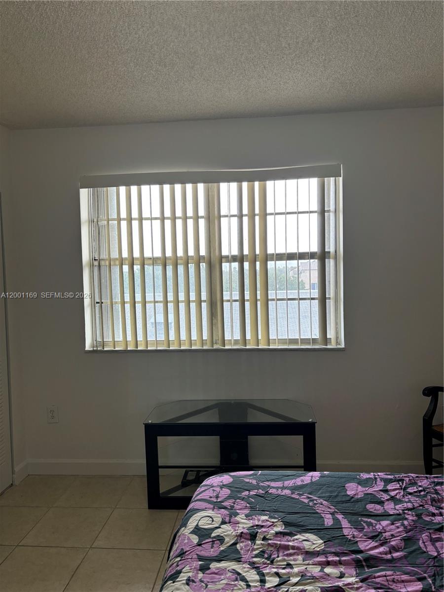 10900 Southwest 104th Street, Unit 303 Miami, FL 33176 - Photo 17 of 40 a bedroom with a bed and a window