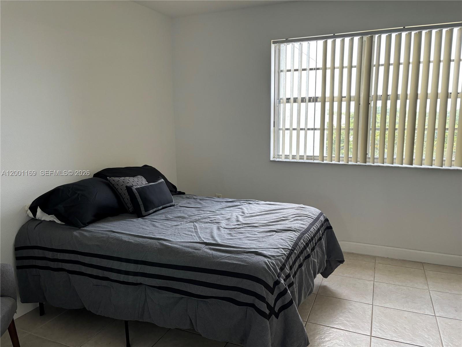 10900 Southwest 104th Street, Unit 303 Miami, FL 33176 - Photo 21 of 40 a bedroom with a bed and a window