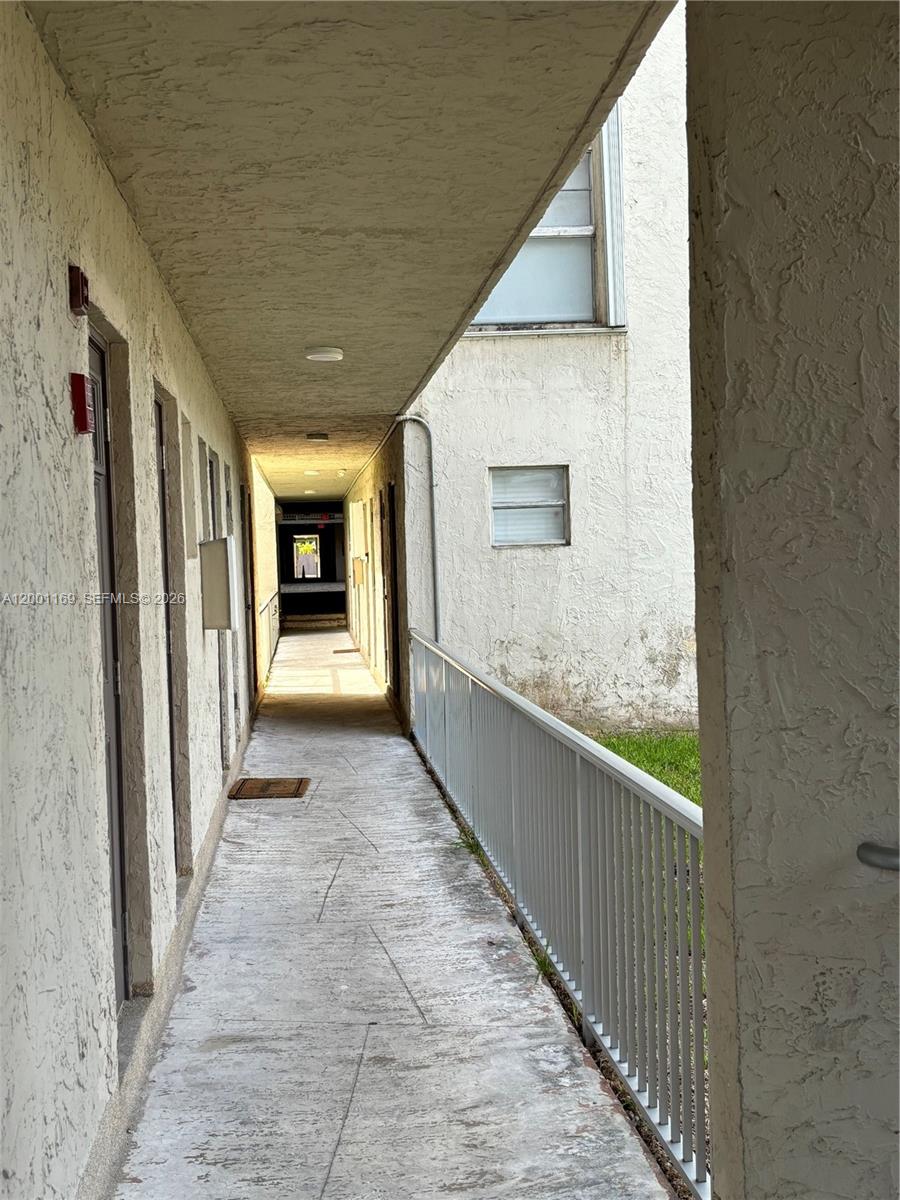 10900 Southwest 104th Street, Unit 303 Miami, FL 33176 - Photo 6 of 40 a view of hallway with stairs