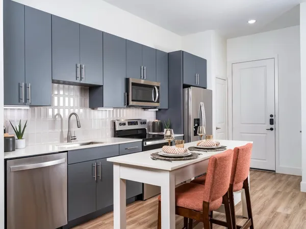 a kitchen with a sink a microwave and refrigerator