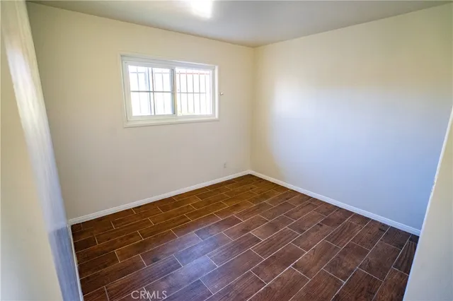 a view of a room with wooden floor and fan