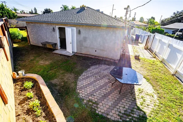 a view of a house with backyard and sitting area