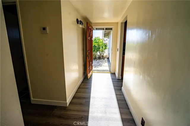 a view of a hallway with wooden floor