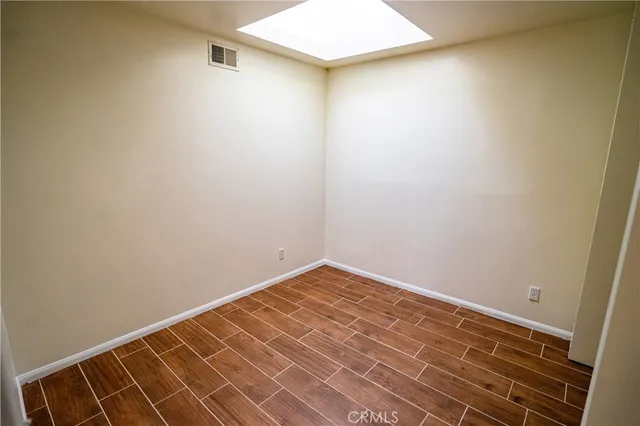 a view of a room with wooden floor and a sink