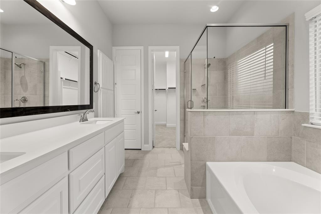 3539 Helios Lane Corinth, TX 76208 - Photo 20 of 33 a bathroom with a bathtub and a sink