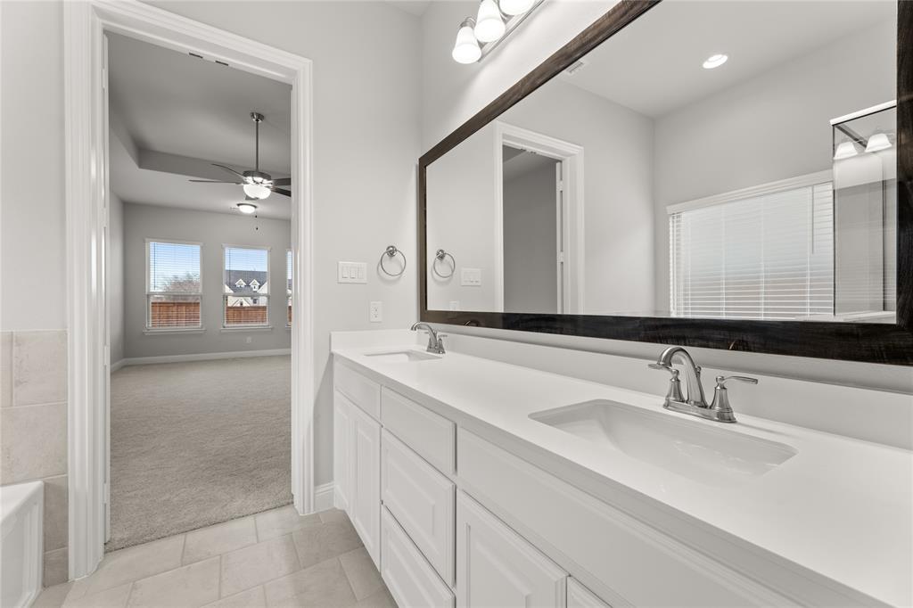 3539 Helios Lane Corinth, TX 76208 - Photo 21 of 33 a bathroom with a sink and a mirror