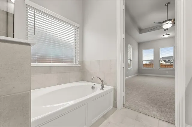 a white bath tub sitting next to a bathroom