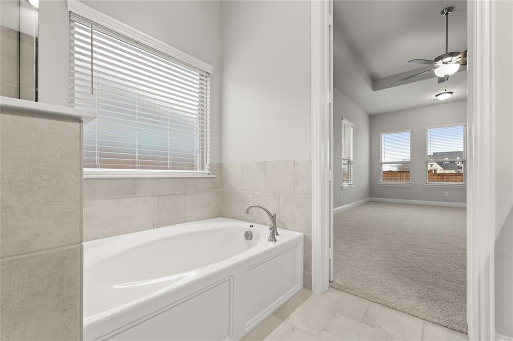 3539 Helios Lane Corinth, TX 76208 - Photo 22 of 33 a white bath tub sitting next to a bathroom