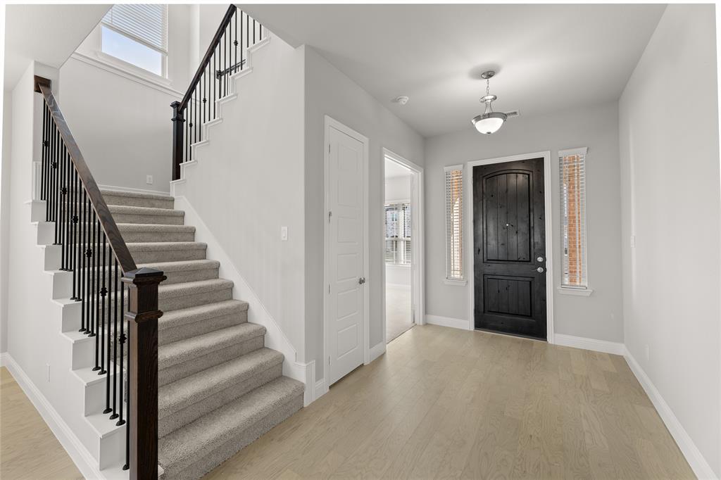 3539 Helios Lane Corinth, TX 76208 - Photo 9 of 33 a view of a hallway with wooden floor and entryway