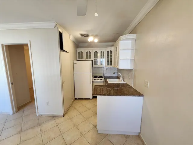 a kitchen with a refrigerator and a sink