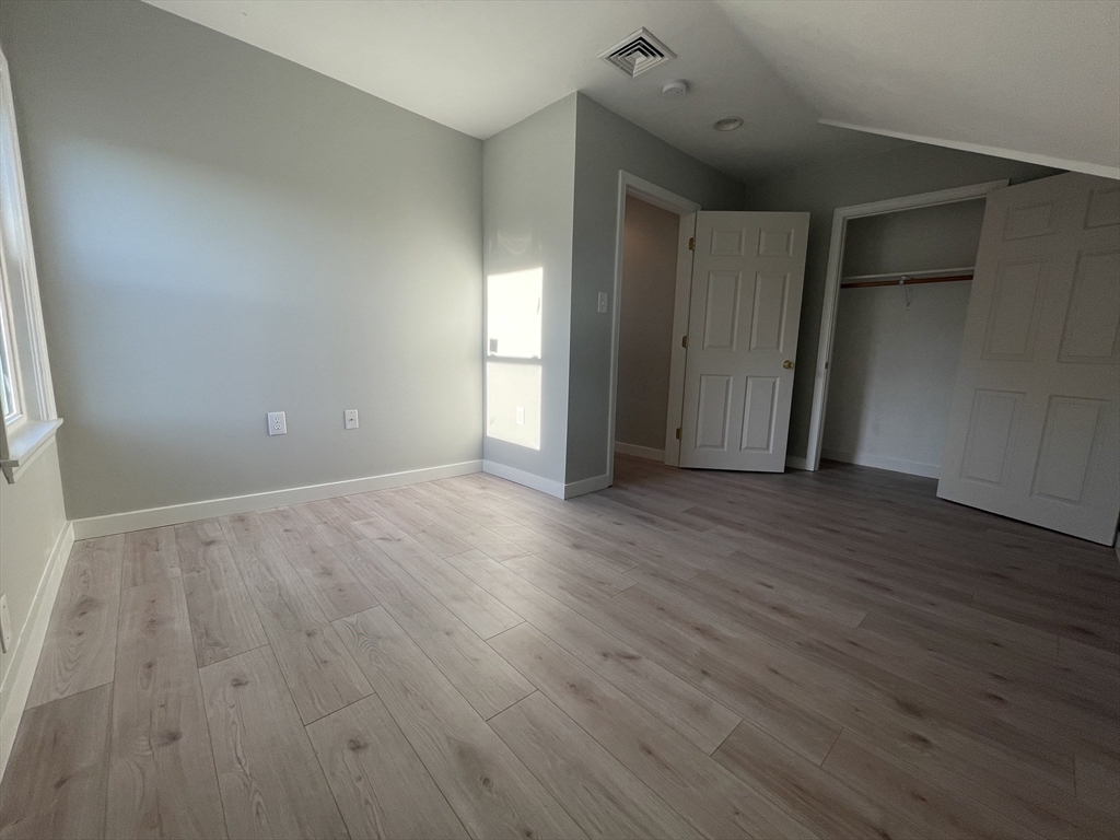 97 Cottage Street, Unit 2 Northbridge, MA 01588 - Photo 11 of 14 a view of an empty room with wooden floor