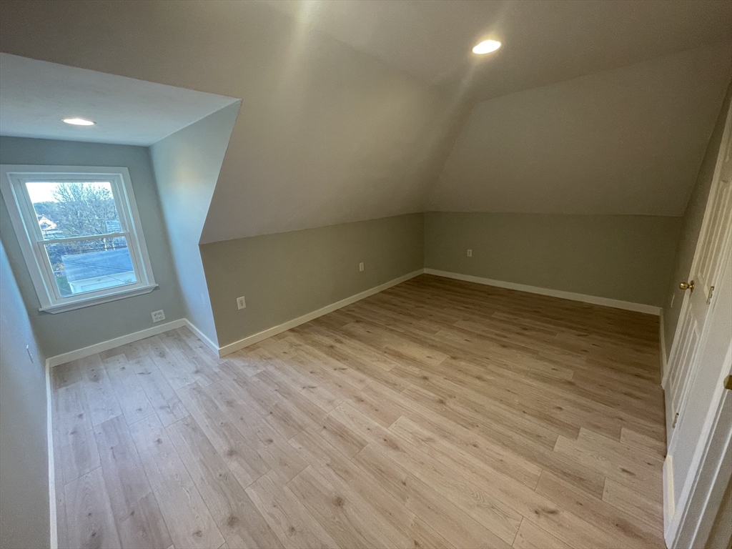 97 Cottage Street, Unit 2 Northbridge, MA 01588 - Photo 13 of 14 an empty room with wooden floor and windows