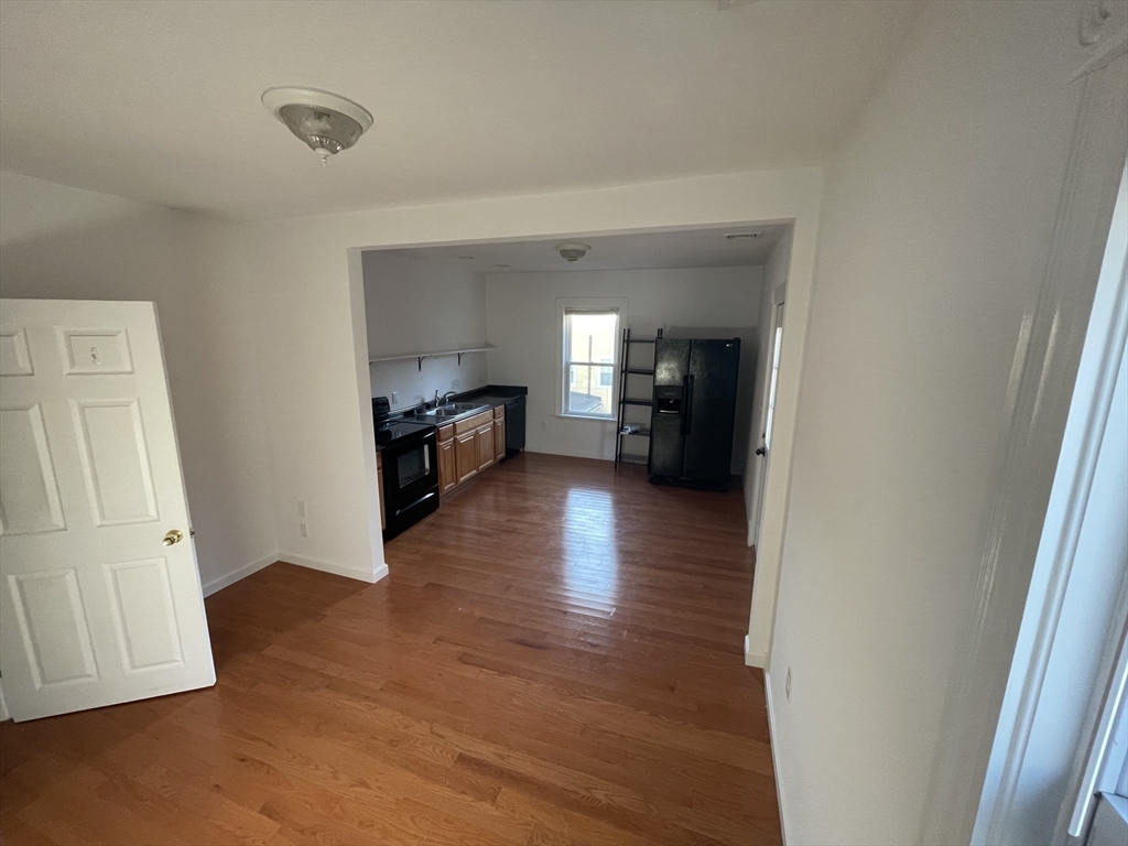 97 Cottage Street, Unit 2 Northbridge, MA 01588 - Photo 2 of 14 wooden floor in an empty room with a window