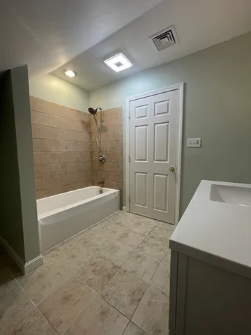 a bathroom with a bathtub and a shower