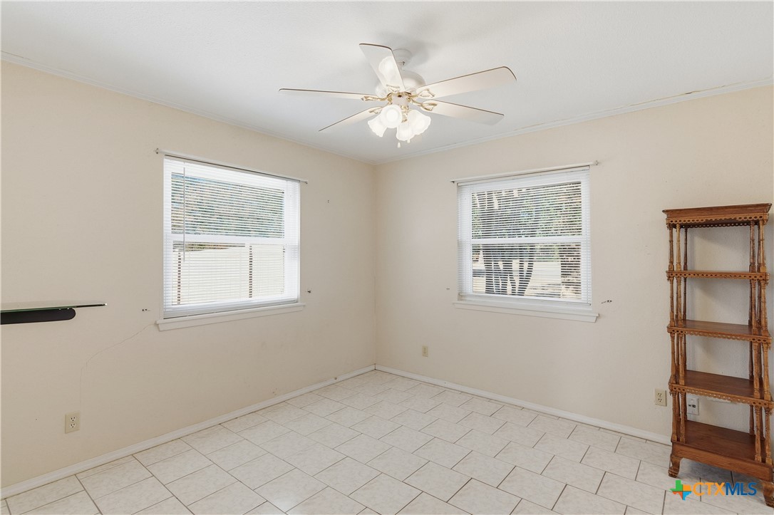 151 Hillside Street Seguin, TX 78155 - Photo 15 of 33 an empty room with windows and fan