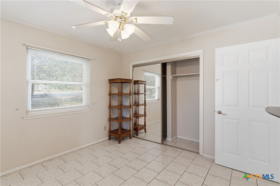 151 Hillside Street Seguin, TX 78155 - Photo 16 of 33 an empty room with chandelier fan and windows