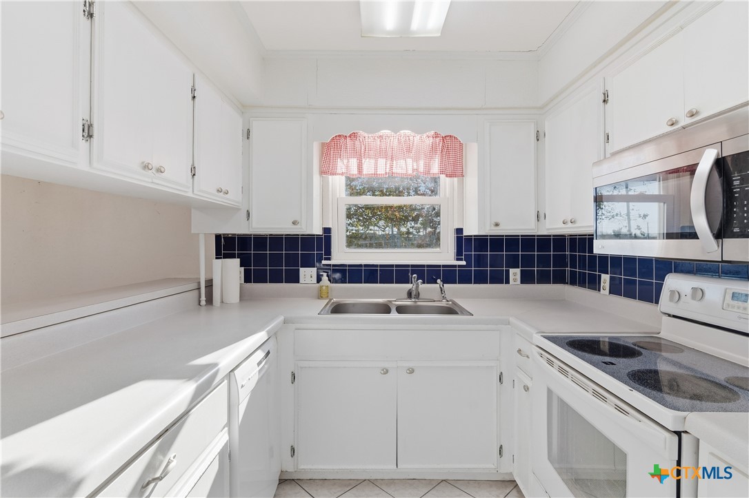151 Hillside Street Seguin, TX 78155 - Photo 9 of 33 a kitchen with a sink stove top oven and cabinets