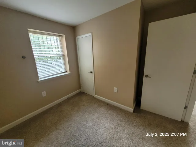 a bathroom with a toilet a sink and a window