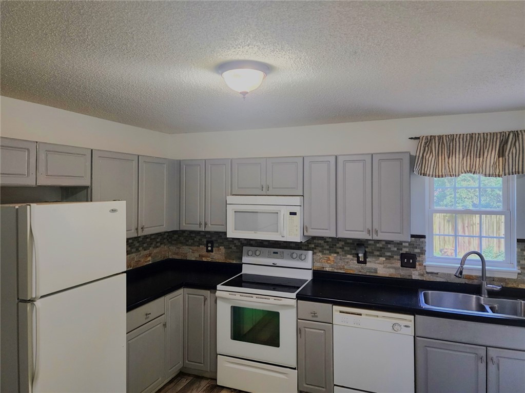 328 Springfield Circle Easley, SC 29642 - Photo 6 of 29 A well-appointed kitchen features ample gray cabinetry and essential appliances for everyday living.