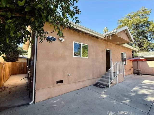 a view of backyard with a large tree