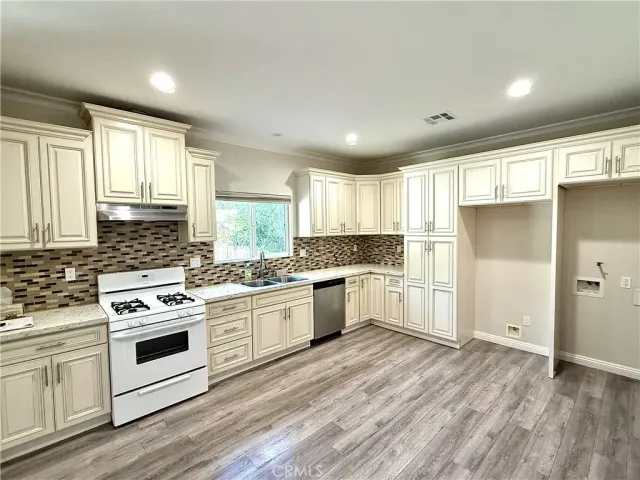 a kitchen with a stove a sink and a refrigerator