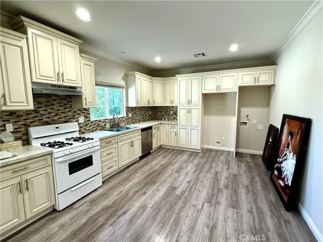 a kitchen with stainless steel appliances granite countertop a stove and a refrigerator