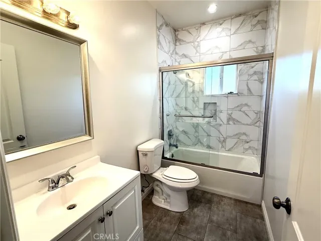a bathroom with a sink mirror toilet and shower