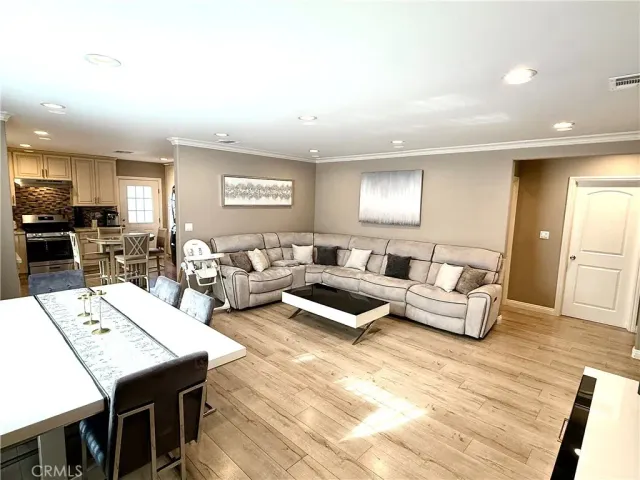 a living room with lots of furniture and a wooden floor